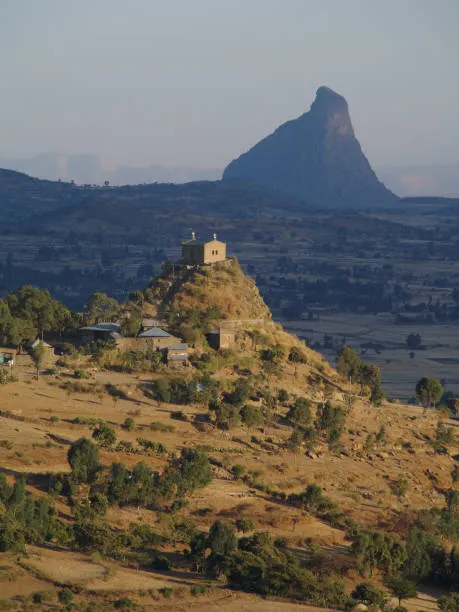 Axum highlands landscape with Orthodox church on hilltop and dramatic rock formations
